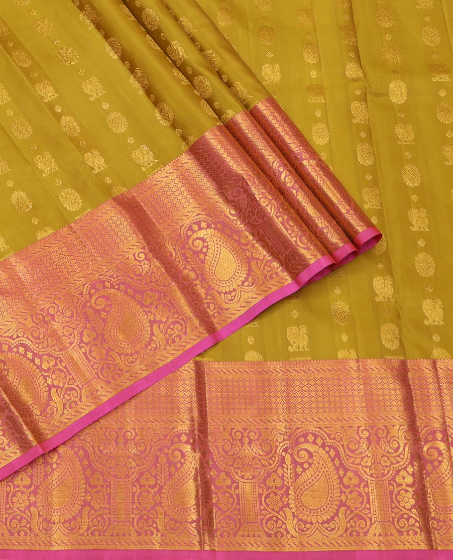 Green Pure Silk Half-Saree, Adorned with Mayil-Chakram Buttas All Over Its Skirt, Complemented by Contrast Border of Puli Nagam, Jaal, and Arumbu Manga Designs, Paired with a Contrast Blouse, and Comes with a Zari Design Woven Dhavani
