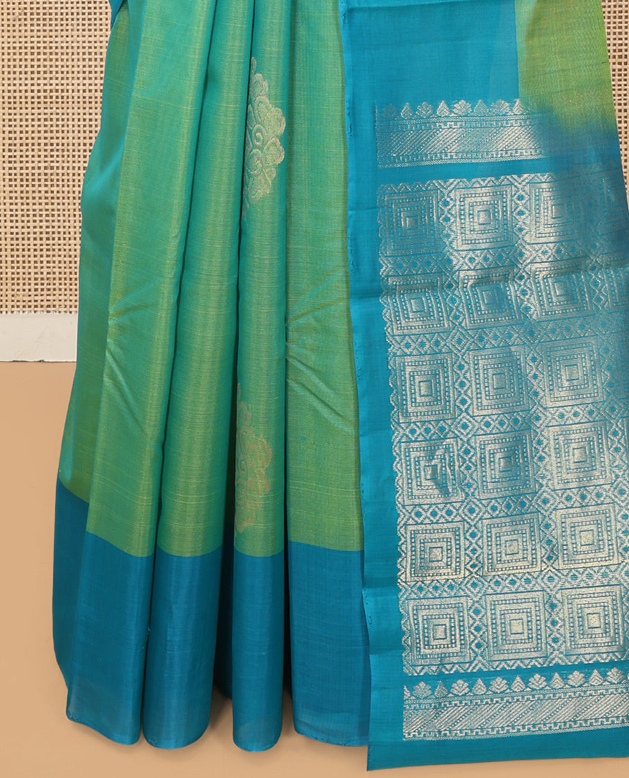 Green Cotton Saree, Accentuated with Zari Buttas, a Contrast Zari Butta Border, a Geometric Pallu, and a Contrast Blouse