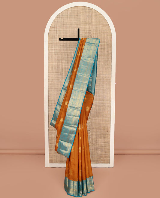 Orange Vasundhara Lite Silk Mix Saree, Detailed with Mayil, Chakra, and Iruthalai Pakshi Buttas, Complemented by Contrast Border of Thilakam Mokku, Mayil, Manga, Vanki, and Mayil Kann Designs, Opulently Embellished Jaal Pallu, and a Contrast Blouse