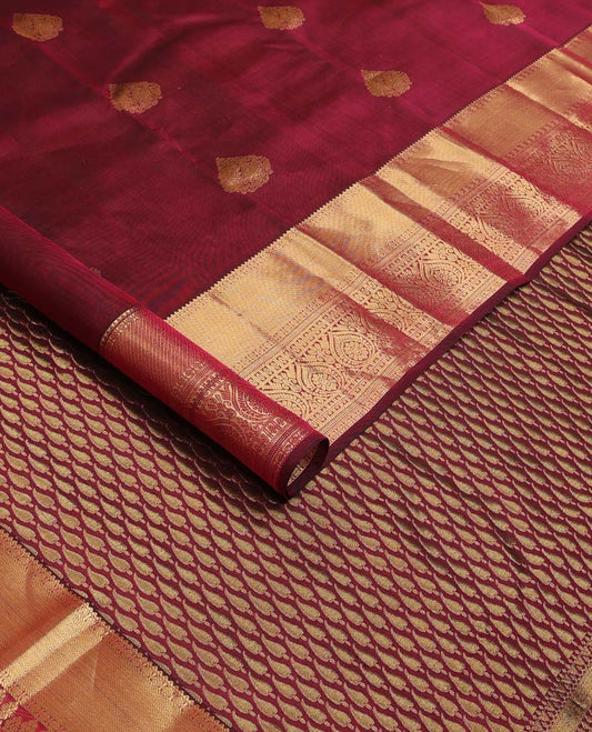 Maroon zari buttas Vasundhara silk mix saree, zari border of rekku, rudraksham,vanki, and thilakam designs, and manga motifs steeped pallu