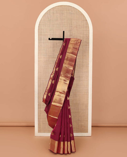 Maroon zari buttas Vasundhara silk mix saree, zari border of rekku, rudraksham,vanki, and thilakam designs, and manga motifs steeped pallu