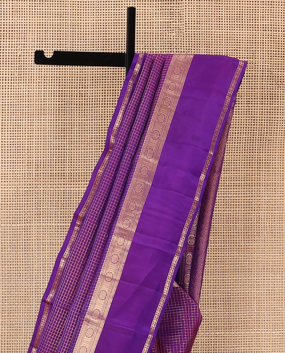 Purple zari checked Vasundhara silk mix saree, zari rettai pettu border of manga, muthu, banaras, and laddu kamalam designs, and intricate pallu