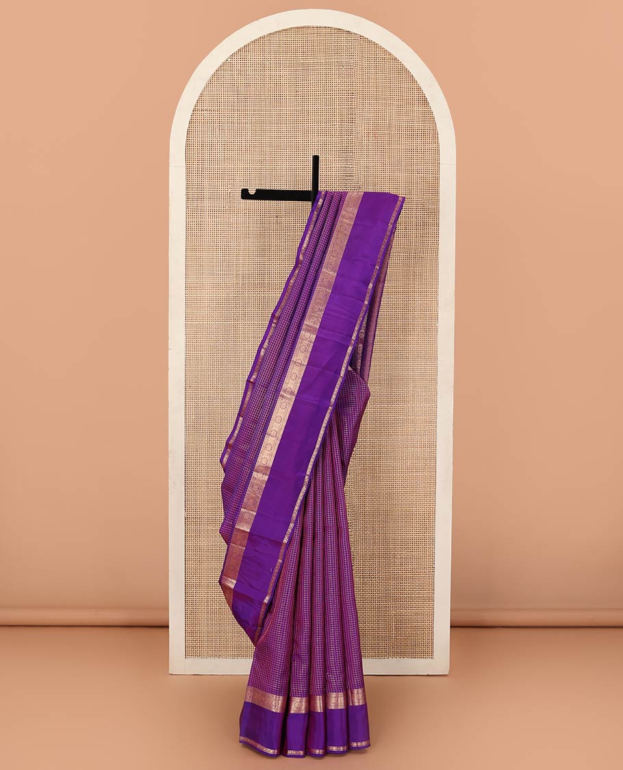Purple zari checked Vasundhara silk mix saree, zari rettai pettu border of manga, muthu, banaras, and laddu kamalam designs, and intricate pallu