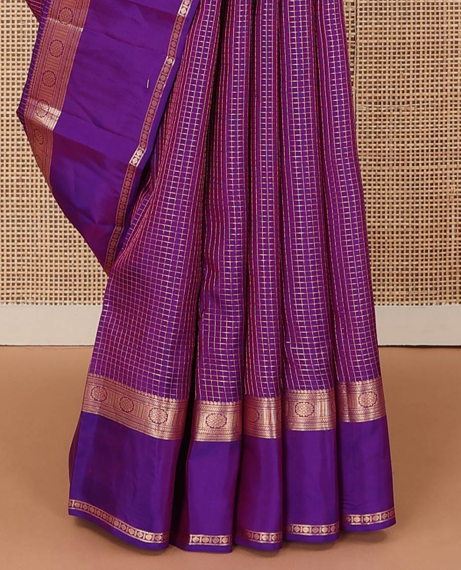Purple zari checked Vasundhara silk mix saree, zari rettai pettu border of manga, muthu, banaras, and laddu kamalam designs, and intricate pallu