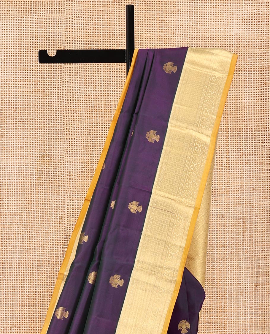 Purple Vasundhara Silk Saree, Elevated with Iruthakshi Buttas All Over Its Body, Complemented by a Contrast Border of Rekku, Then Kuli Kann, and Kodi Visiry Designs, Grand Jaal Pallu, and Paired with a Contrast Blouse