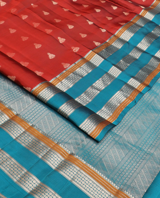 Rust zari buttas silk saree, contrast border of manga mokku,muthu,kathir & rudraksham motifs & geometric patterned pallu