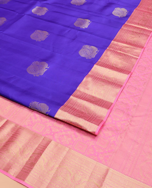 Blue Vasundhara Silk Saree Prettified with Mayil Buttas, Complemented by a Contrast Border of Thilakam, Kathir, Kuyil Kann, Laddu Kamalam, Iru Thalai Pakshi, and Yaali Designs, Pallu Adorned with Geometric Designs, and Paired with a Contrast Blouse