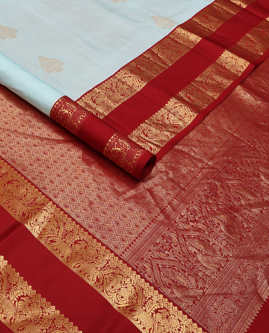 Baby blue zari buttas silksaree, contrast jaal pallu & rettai pettu border features annam,mayil & yaanai designs