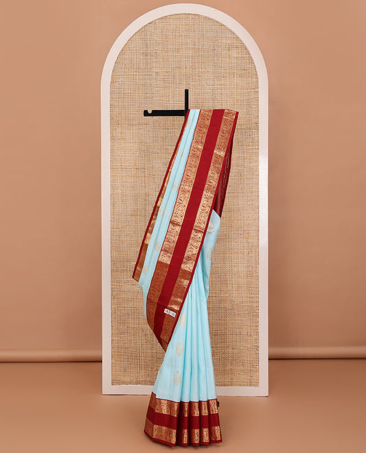 Baby blue zari buttas silksaree, contrast jaal pallu & rettai pettu border features annam,mayil & yaanai designs