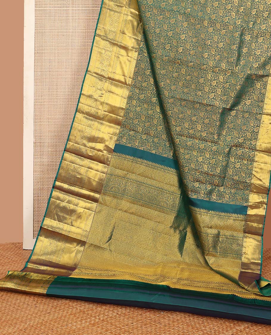 Green floral jacquard wedding silk saree, traditional zari border of thilakam mokku, kamalam, and mayil kann, and jaal pallu