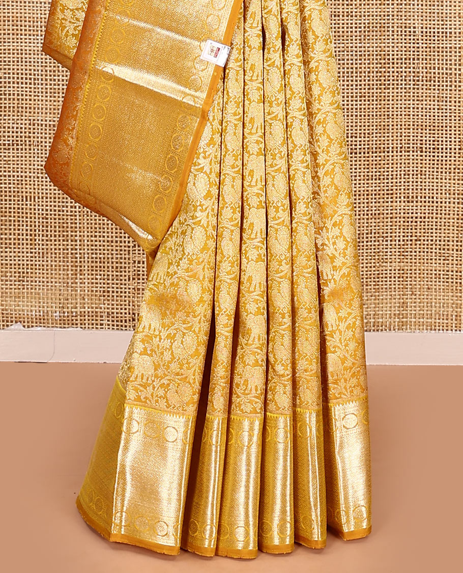 Yellow jacquard kanchipuram silk saree, zari border of rekku, neli, rudraksham, and jaal designs, and jaal pallu