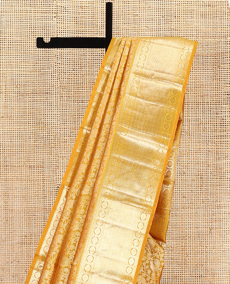 Yellow jacquard kanchipuram silk saree, zari border of rekku, neli, rudraksham, and jaal designs, and jaal pallu