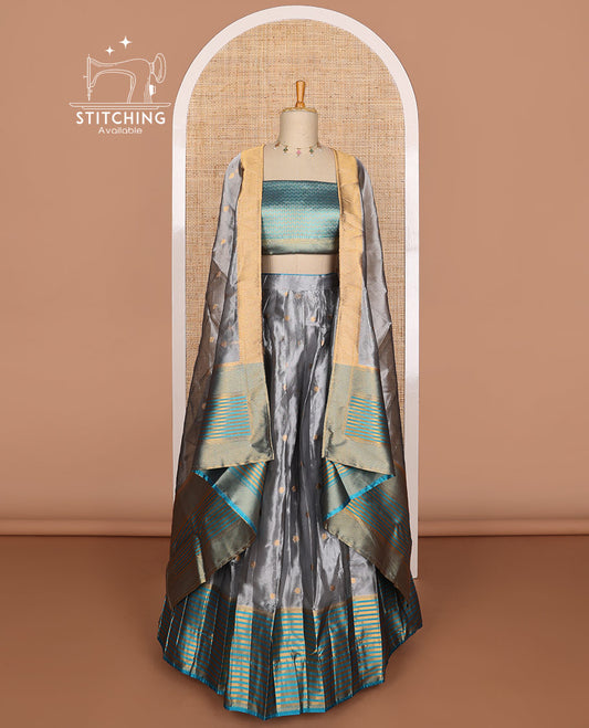 Dark grey buttas tissue half saree with contrast zari design border, jaal design blouse & floral design dhavani