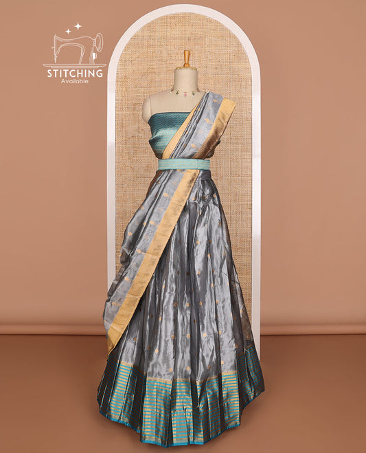 Dark grey buttas tissue half saree with contrast zari design border, jaal design blouse & floral design dhavani