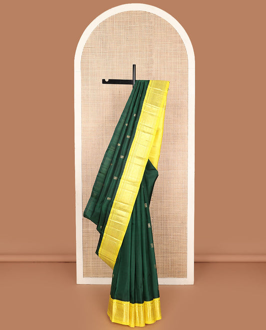 Green zari buttas Kanchipuram silk saree, contrast one-sided korvai border of thilakam mokku, banaras, muthu, and jaal designs, and zari design pallu