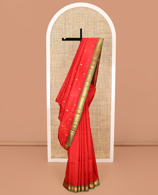 Red Kanchipuram Silk Saree, Embellished with Zari Buttas All Over Its Body, Complemented by a Contrast One-Sided Border of Banaras, and Jaal Designs, Pallu of Zari Designs, and Comes Without a Blouse