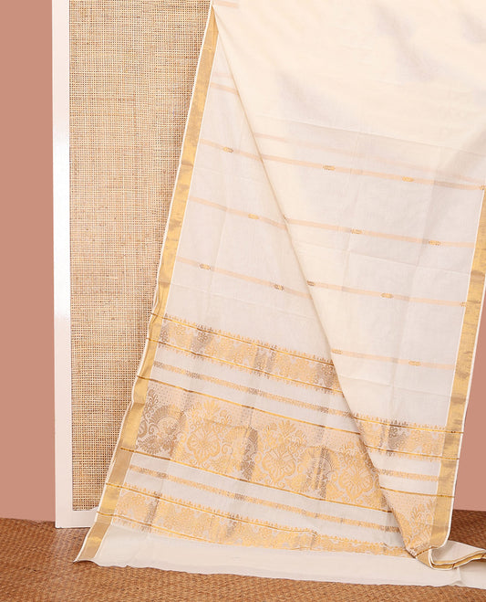 Cream Kerala Saree, Beautified with Zari Stripes on Its Body, Subtly Sparkled Zari Bavanji Border, Opulently Zari Embellished Pallu, and Paired with a Matching Blouse