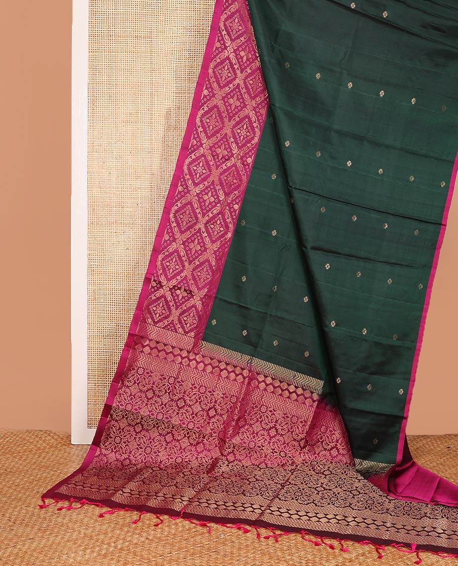 Deep green zari buttas soft silk saree, contrast jaal patterned border, and pallu of intricate design