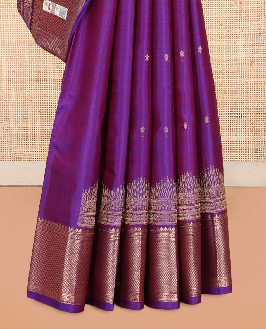 Violet Vasundhara Silk Saree Gracefully Embellished with Zari Buttas, Highlighted by a Zari Border Featuring Thilakam Mokku, Muthu, Cross Kamalam, and Mayil Kann Designs, Elegantly Embellished Pallu, and Paired with a Matching Blouse