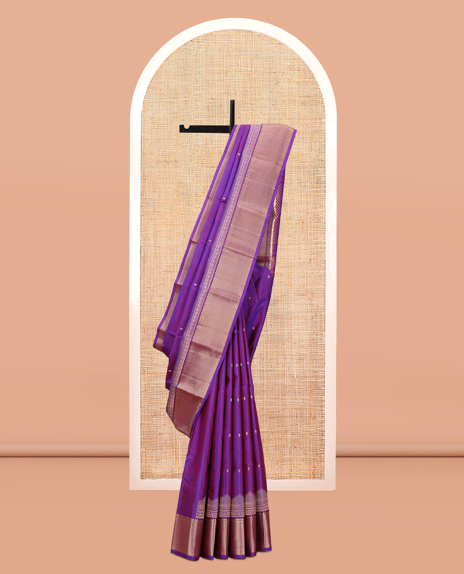 Violet Vasundhara Silk Saree Gracefully Embellished with Zari Buttas, Highlighted by a Zari Border Featuring Thilakam Mokku, Muthu, Cross Kamalam, and Mayil Kann Designs, Elegantly Embellished Pallu, and Paired with a Matching Blouse