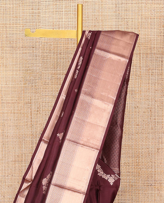 Brown Vasundhara Silk Saree Elegantly Sparkled with Floral Jaal Design All Over Its Body, Complemented by a Zari Border of Thilakam Mokku, Lavangam, Kathir, and Jaal Designs, Pallu Depicting Zari Jaal Designs, and Paired with a Matching Blouse