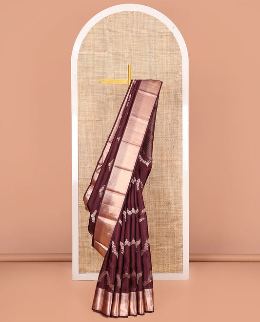 Brown Vasundhara Silk Saree Elegantly Sparkled with Floral Jaal Design All Over Its Body, Complemented by a Zari Border of Thilakam Mokku, Lavangam, Kathir, and Jaal Designs, Pallu Depicting Zari Jaal Designs, and Paired with a Matching Blouse