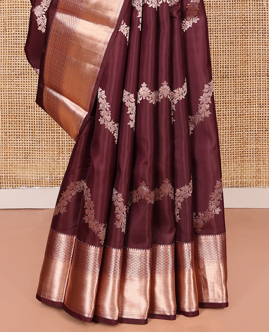 Brown Vasundhara Silk Saree Elegantly Sparkled with Floral Jaal Design All Over Its Body, Complemented by a Zari Border of Thilakam Mokku, Lavangam, Kathir, and Jaal Designs, Pallu Depicting Zari Jaal Designs, and Paired with a Matching Blouse