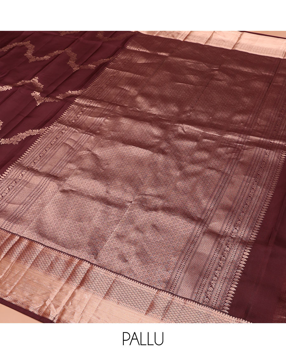 Brown Vasundhara Silk Saree Elegantly Sparkled with Floral Jaal Design All Over Its Body, Complemented by a Zari Border of Thilakam Mokku, Lavangam, Kathir, and Jaal Designs, Pallu Depicting Zari Jaal Designs, and Paired with a Matching Blouse