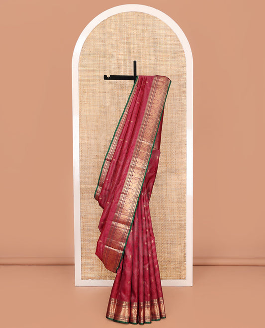 Reddish Pink Vasundhara Silk Saree, Majestically Detailed with Zari Buttas and Micro-Checks on Its Body, Highlighted by Zari Border of Rekku, Muthu, Banaras, Rudraksham, and Mayil Designs, Diagonally Striped Pallu, and Paired with a Contrast Blouse