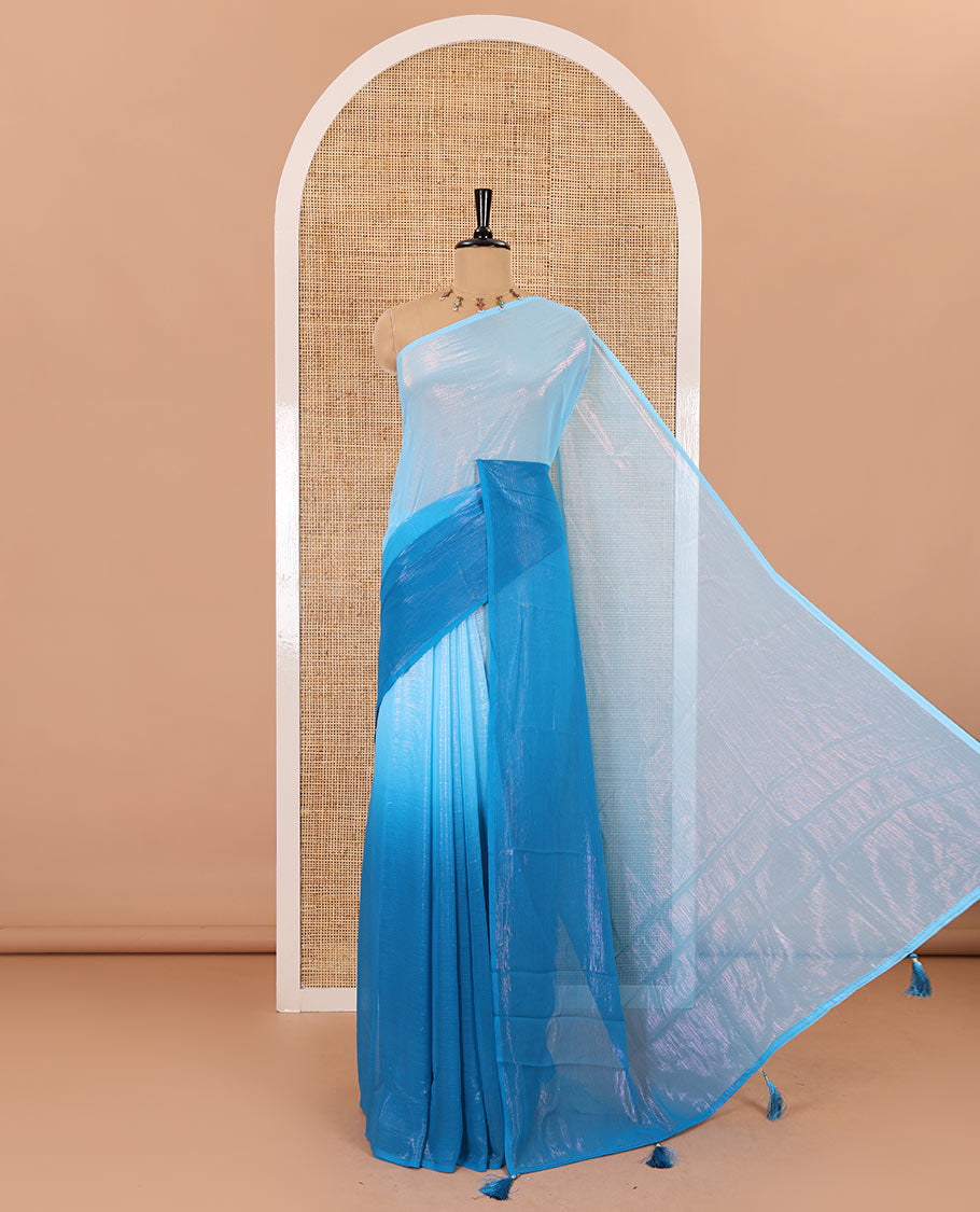 Borderless blue ombre-toned gleaming Shimmer Georgette saree, self-pallu with tassels and a plain blue blouse