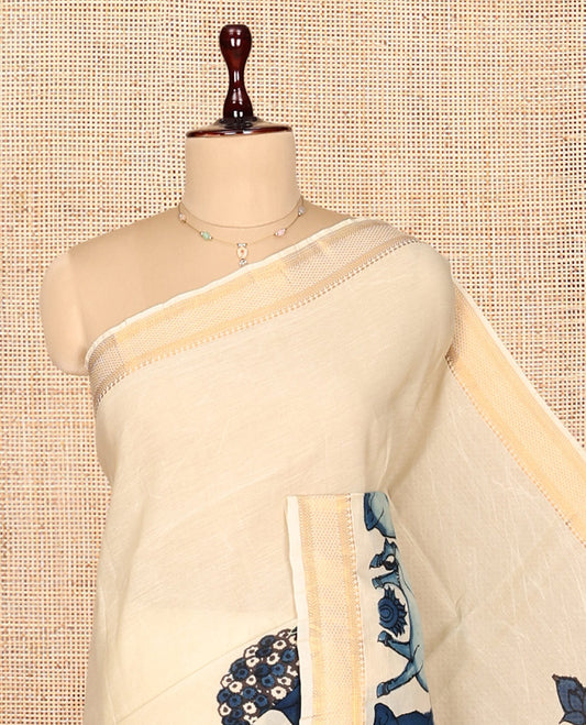 Cream Kalamkari Silk Saree, Crafted with Flora-Fauna Motifs, a Traditional Zari Border, Peacock Kalamkari Pallu, and a Matching Blouse