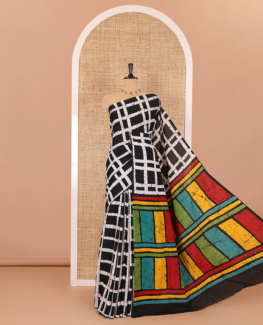 Black checked batik printed mul cotton saree, contrast kaleidoscope colored batik printed pallu, and a contrast batik printed blouse