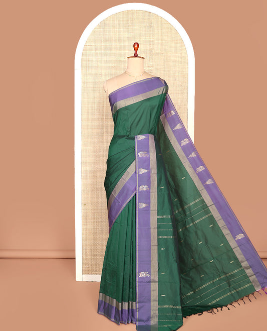 Green Aarani Silk Saree, Adorned with Zari Buttas All Over Its Body, Complemented by a Contrast Border of Peacock and Temple Border, Pallu of Zari Designs, and Paired with a Matching Blouse