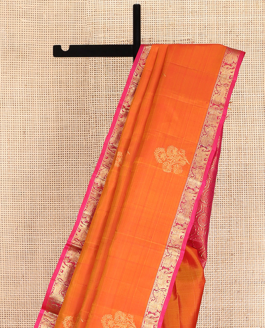 Orange Kanchipuram Silk Saree, Accentuated with Zari Buttas All Over Its Body, Complemented by Contrast Border of Yaanai and Mayil Designs, Grand Floral Jaal Pallu, and Paired with a Contrast Blouse