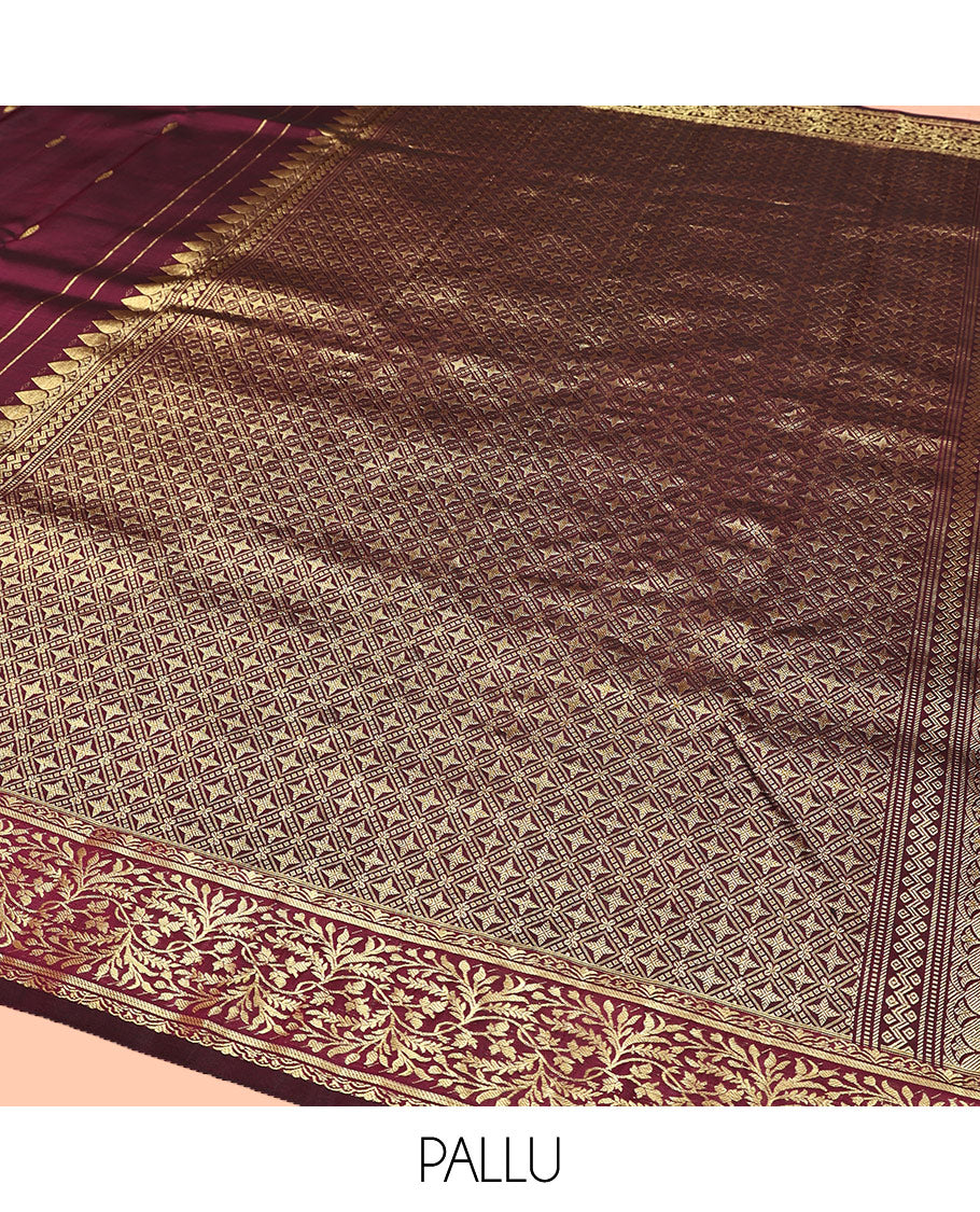 Wine Kanchipuram Silk Saree, Embellished with Zari Buttas on Its Body, Highlighted by a Zari Border of Floral Designs, Pallu of Jaal Designs, and Paired with a Matching Blouse