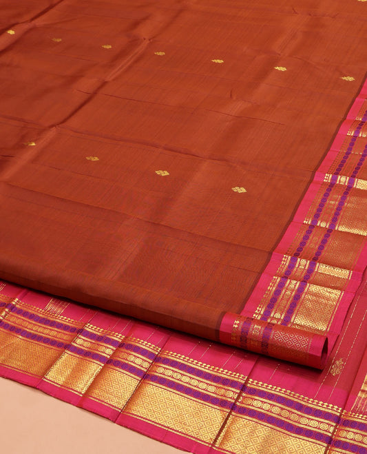 Brown Kanchipuram Silk Saree, Woven with Zari Buttas on Its Body, Complemented by a Contrast One-Sided Border of Panner Sombu, Banaras, Rudraksham, and Mayil Kann Designs, Pallu of Zari Designs, and Comes Without a Blouse