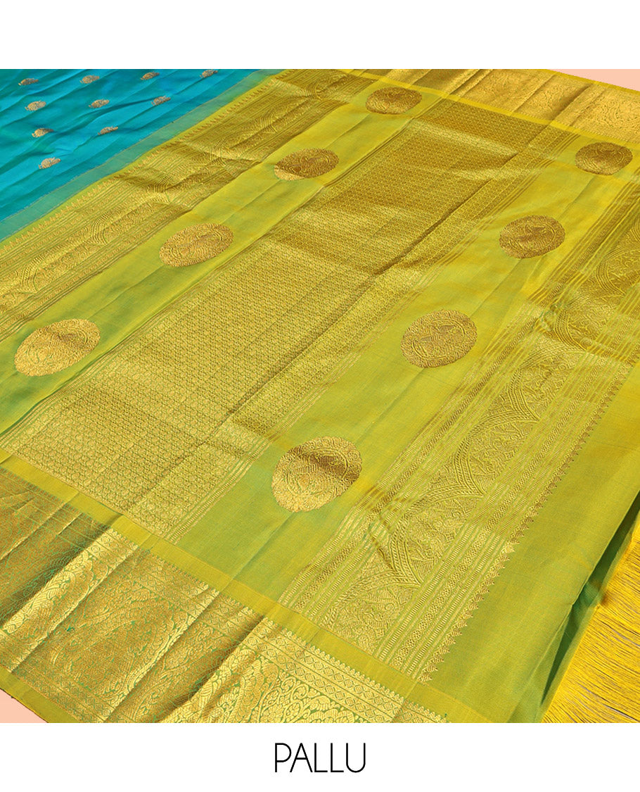 Blue Kanchipuram Silk Saree, Decorated with Mayil Buttas All Over Its Body, Complemented by a Contrast Border of Thilakam Mokku, Laddu Kamalam, and Mayil Designs, Pallu of Gandaberunda Designs, and Paired with a Contrast Blouse