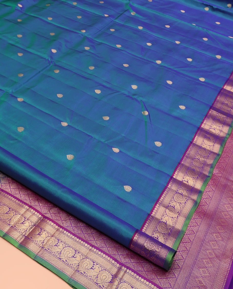 Blue Kanchipuram Silk Saree, Mesmerized with Zari Buttas All Over Its Body, Complemented by a Contrast Border of Thilakam, Mayil Kann, Muthu, and Mayil Designs, Grand Jaal Pallu, and Paired with a Contrast Blouse
