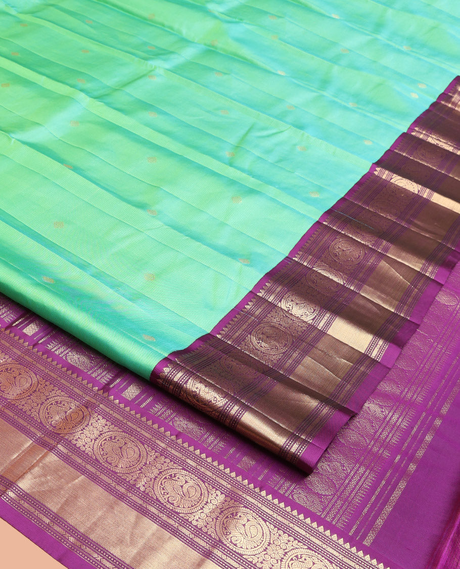 Rexona Green Vasundhara Silk Saree, Beautified with Sparse Stripes and Zari Buttas, Complemented by a Contrast Border of Thilakam, Banaras, Muthu, and Round Mayil Designs, Pallu Steeped with Traditional Designs, and Paired with a Contrast Blouse