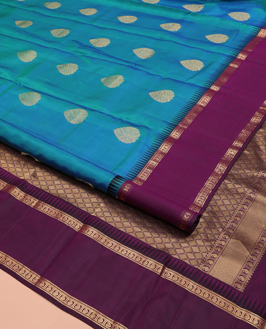 Blue Vasundhara Silk Saree, Delicately Woven with Zari Buttas All Over Its Body, Complemented by a Contrast Rettai Pettu Temple Border of Banaras, and Manga Designs, Grand Jaal Pallu, and Paired with a Contrast Blouse