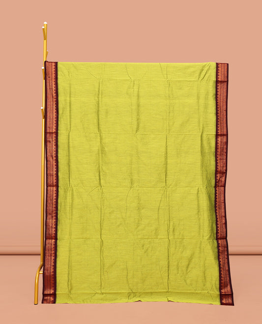 Light Green Plain Kalyani Cotton Saree, Complemented by a Contrast Traditional Zari Design Temple Border, Pallu Features Temple Zari Designs, and Paired with a Contrast Blouse