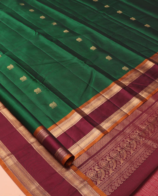 Green Vasundhara Lite Silk Mix Saree Features Mayil Buttas and Stripes, a Contrast Rettai Pettu Border of Salngai, Banaras, Neli, Kuyil, Kann, and Vanki Designs, Mayil Kann Pallu, and a Contrast Blouse
