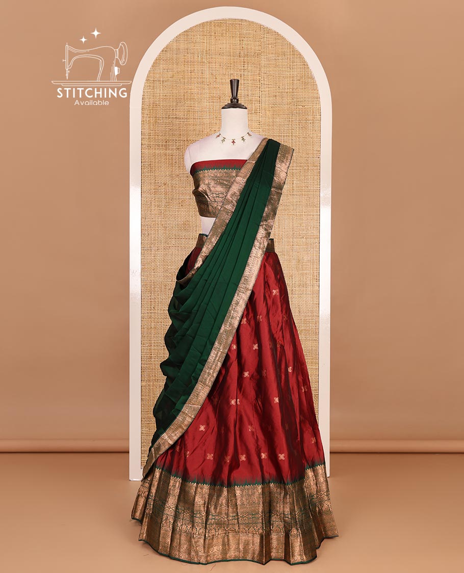 Maroon taffeta silk half saree, zari buttas with contrast green traditional zari border, matching zari blouse, and contrast plain zari border dhavani