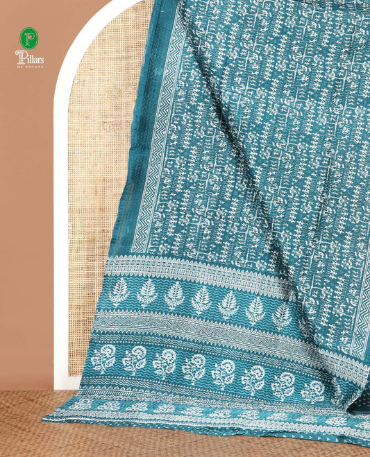 Blue batik-style warli printed Litch crushed saree, batik chevron border, floral-geometric printed pallu & triangle motif blouse