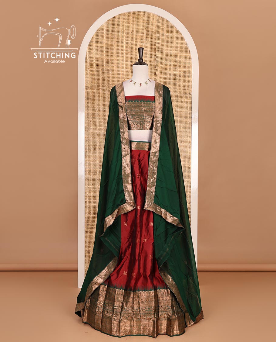 Maroon taffeta silk half saree, zari buttas with contrast green traditional zari border, matching zari blouse, and contrast plain zari border dhavani