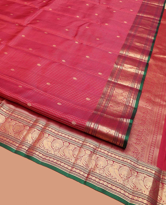 Reddish Pink Vasundhara Silk Saree, Majestically Detailed with Zari Buttas and Micro-Checks on Its Body, Highlighted by Zari Border of Rekku, Muthu, Banaras, Rudraksham, and Mayil Designs, Diagonally Striped Pallu, and Paired with a Contrast Blouse