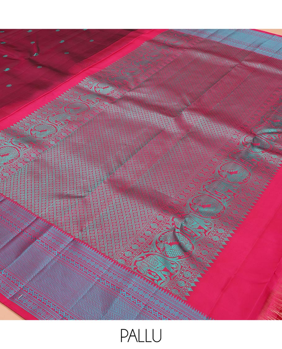 Wine Kanchipuram Silk Saree, Adorned with Mayil-Chakram Buttas All Over Its Body, Complemented by a Contrast Border of Thilakam, Banaras, Muthu, Rudraksham, Neli, and Vanki Designs, and Pallu Steeped with Kamalam Designs, and Paired with a Contrast Blouse