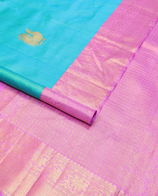 Light blue checked, mayil buttas silk saree with contrast border of thilakam mokku, muthu, paun design & floral design pallu
