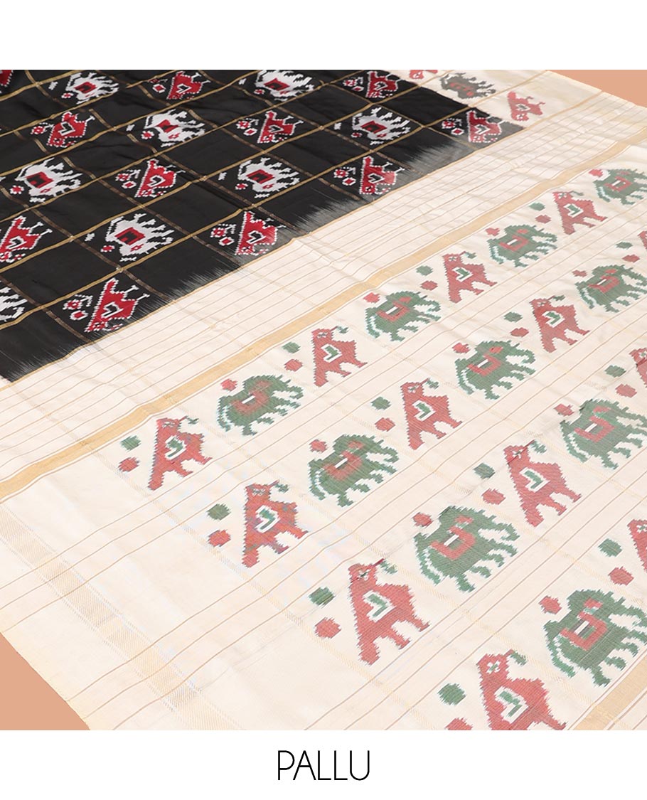 Black Ikkat Silk Saree, Impeccably Styled with Patola-Style Parrot-Elephant Butta Enclosed Checks on Its Body, Complemented by a Contrast Patola-Style Parrot-Elephant Butta Enclosed Border, Pallu of the Same Motifs, and Paired with a Contrast Blouse