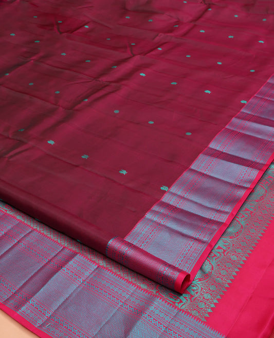 Wine Kanchipuram Silk Saree, Adorned with Mayil-Chakram Buttas All Over Its Body, Complemented by a Contrast Border of Thilakam, Banaras, Muthu, Rudraksham, Neli, and Vanki Designs, and Pallu Steeped with Kamalam Designs, and Paired with a Contrast Blouse